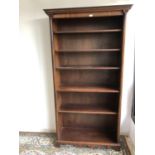 Mahogany open bookcase with 5 adjustable shelves flanked by reeded columns below a dentil cornice