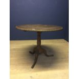 C19th Oak circular pedestal table, the tilt top with carved edging & carved tripod legs & feet 88 cm