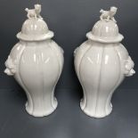 Pair of EICHHOLTZ white china fluted vases and covers with panther mask handles and lion finials