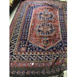Red ground Persian rug with central panel & multi borders with all over stylized design 295 X 194 cm