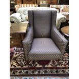 Large square framed arm chair on 4 mahogany tapered legs to castors upholstered in contemporary blue