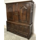 C17/18th cupboard with 5 panelled base above 2 drawers, the top 2 doors opening to reveal a single