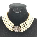 4 Strand pearl necklace with yellow metal & diamond clasp Provenance Purchased in a shop in Brazil