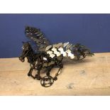 Contemporary sculpture of Pegasus made out of recycled motor parts. In the style of the Scottish