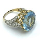 Unmarked yellow metal aquamarine diamond dress ring, central round free cut aquamarine 19mm in