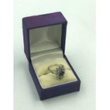 White gold sapphire & diamond flower head style ring