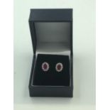 Good pair of 18 ct white gold ruby & diamond cluster earrings of 1.69 cts