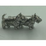 Silver brooch in the form of 2 dogs