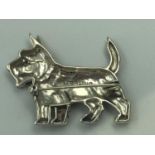 Silver figure of a terrier in the form of a brooch