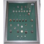 Golf silver spoons, buttons, medals and badges. Framed display comprising twelve silver cricket