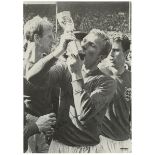 Bobby Moore. West Ham United & England. Mono 'Walkerprint' photograph of Bobby Moore kissing the