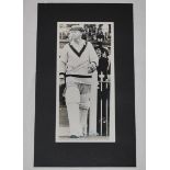 Don Bradman. Mono photograph of Bradman, wearing Australian cap and sweater, walking out to bat with