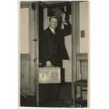 Don Bradman 1953. Original mono press photograph of Bradman doffing his hat and holding briefcase