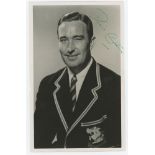 Denis Compton. 'Brylcreem'. Mono real photograph postcard of Compton wearing M.C.C. touring