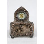 Cricket clock. Unusual and attractive silver plated mantel clock of arched form, decorated in relief