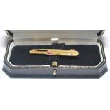 Cricket bat tie clip/brooch. Nine carat gold cricket bat tie clip/brooch inlaid with three small