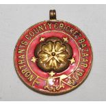 'Northants County Cricket Bazaar 1909'. Gold metal medal with county emblem to centre with title