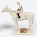 Horse Racing. A crested china figure of a jockey on horse with the crest of 'Newmarket' to base.