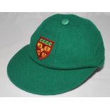 Cumberland County Cricket Club. Green Cumberland C.C.C. cap, by Foster of London, with emblem in