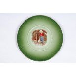 E.P. Kinsella. A green plate with centre image of the boy cricketer in batting pose in front of