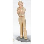 'How's That'. A glazed art deco plaster figure of a cricketer catching the ball, modelled full