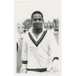 Garry Sobers. Mono real photograph plain back postcard of Sobers, head and shoulders walking off the