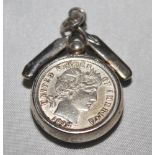 Cricket locket. Silver locket with two American coins, dated 1866 and 1898, encased in a circular