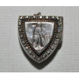 Cricket locket. Attractive silver shield shaped opening locket with batsman at thewicket centre