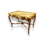 Early 20th Century Carved and Gilt Wood Center Table with Onyx Top. Decorated with carved scroll mo