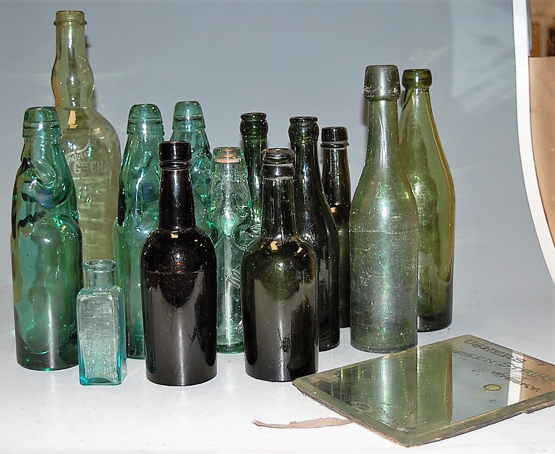 A box of miscellaneous glass bottles to include Walkers Warrington & Burton Ltd examples