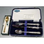 A mid 20th century cased knife, fork and spoon set, each having silver handles, together with a