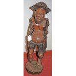 An African rootwood carved figure of a semi-nude standing fisherman, h.66cm