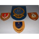 A collection of assorted military shield shaped wall plaques, to include Royal Air Force Flying