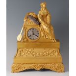 A mid-19th century French gilt bronze mantel clock, the case surmounted with a seated maiden in