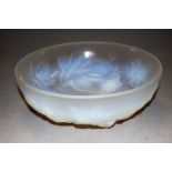 An early 20th century Etling French vaseline glass bowl, relief decorated with leaves and berries,