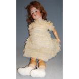 An early 20th century Heubach Koppelsdorf bisque headed doll, having rolling blue eyes and open