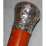 A circa 1900 walking cane having mallacca shaft and silver top