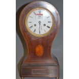 An Edwardian mahogany and satinwood strung balloon shaped mantel clock having an enamel dial with