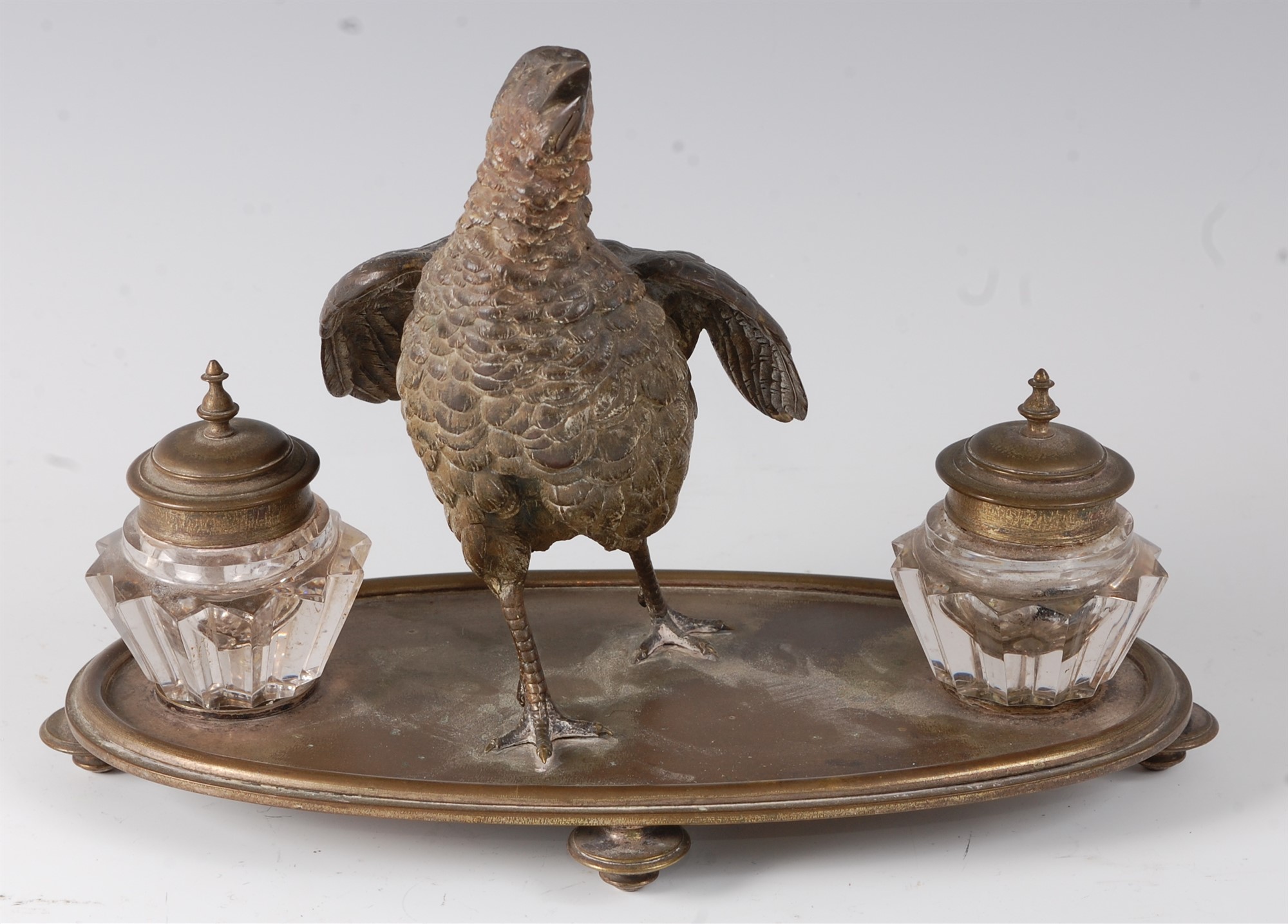 A late 19th century Continental desk stand, surmounted by a central cold painted bronze model of a