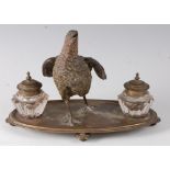 A late 19th century Continental desk stand, surmounted by a central cold painted bronze model of a