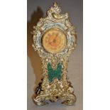 A British Union Clock Company mantel clock housed in a brass surround with a C-scroll decoration,