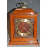 A modern Smith's mahogany cased mantel clock, having a brass chapter ring with Roman numerals,