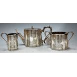 A late Victorian silver bachelor's three piece tea service of serpentine shape having floral