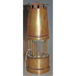 A brass miners safety lamp by the Protector Lamp and Light Co Ltd makers of Eccles, Manchester