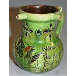 A C.H. Brannan Barham art pottery puzzle jug, on a green ground with incised bird decoration, h.