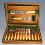 An early 20th century oak cased six place setting canteen of fish cutlery