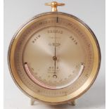 A late 19th century lacquered brass cased cylinderical compensated barometer, the silvered dial with