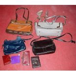 A box of various leather handbags and purses