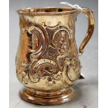 A silver christening mug of bell shape, having a repoussee decoration and flying C-scroll handle