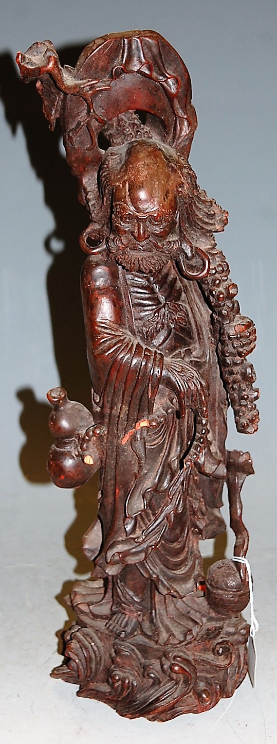 A large mid 20th century carved wooden model of a sage (with losses), height 52cm